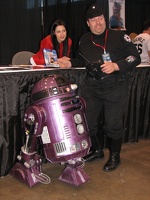 Orli Shashan from Star Wars posing with man who had a remote control R2D2.